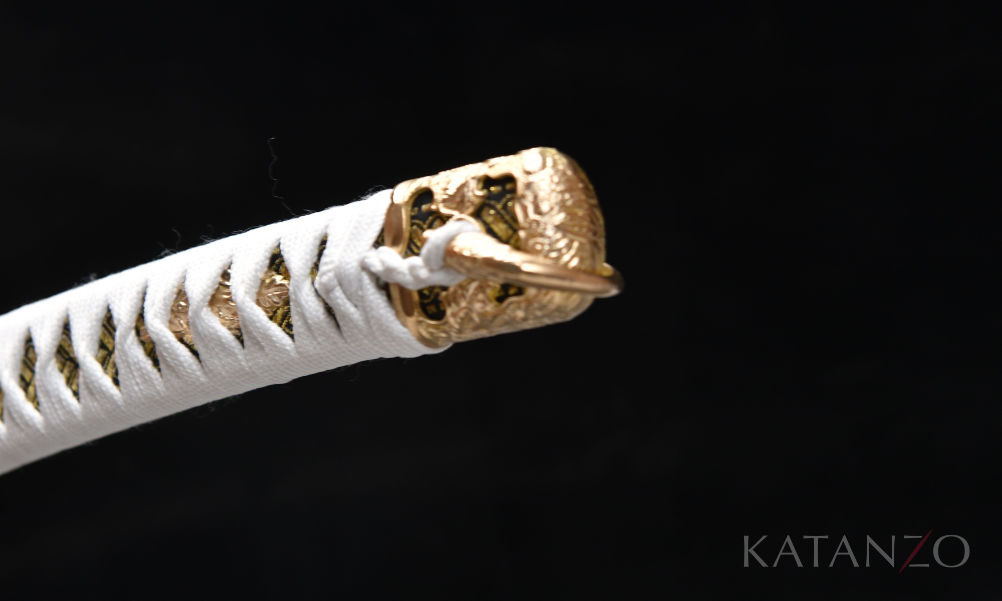 Tsuka mit weisser Seidenwicklung, schwarz-gold gemusterter Habutae-Unterlage